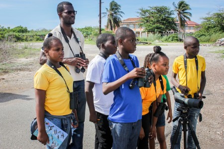 What kind of bird is that? Students of Denham Town Primary with a little help from resident bird expert at National Environment & Planning Agency, Ricardo Miller (second left) were able to identify 5 species of birds at the Old Coal Wharf in the Palisadoes Port Royal Protected Area as part of a bird count held recently in celebration of International Migratory Bird Day, October 9.