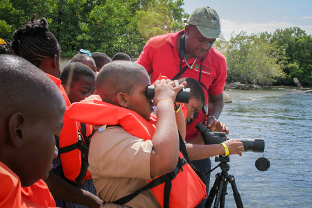 “Do you see the Pelican?” Damian Whyte, environmental officer of the Urban Development Corporation, Jamaica, seems to be asking students of Swallowfield Primary School as he demonstrates how to use the telescope as a part of the Caribbean Waterbird Census 2016 in Palisadoes Port Royal Protected Area. The equipment was donated to NEPA and Jamaica Environment Trust by BirdsCaribbean (photo courtesy of Ava Tomlinson).