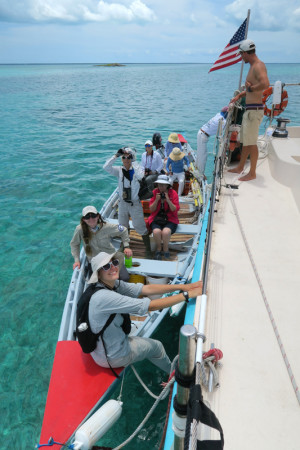 Conservian field team loading into longboat. (Photo © Conservian/ Scott Hecker)