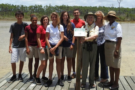 Wetland Trail team with Dr. Batemann, Marilyn Laing, and Erika Gates displaying the certification sign.