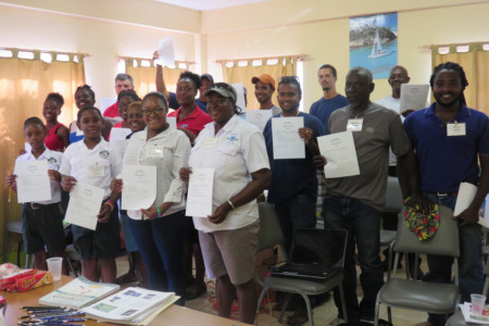 Workshop participants proudly show their signed pledge to help protect Grenadines' seabirds. (photo by Julianna Coffey)