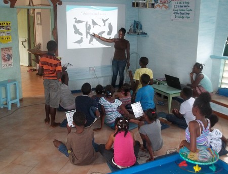 Education Officer Antonia Peters teaching how to identify by birds by their size and shape to the junior group at KIDO. (photo by Marina Fastigi)