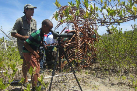 Mount Pleasant child at the spotting scope with ever watchful KIDO co-founder Dario Sandrini. (photo by Marina Fastigi)