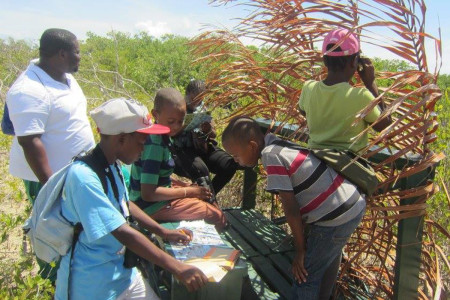 Teacher Mr. Matheson and a few of his keen birding team members from Mount Pleasant observe birds from our blind. (Photo by Marina Fastigi).