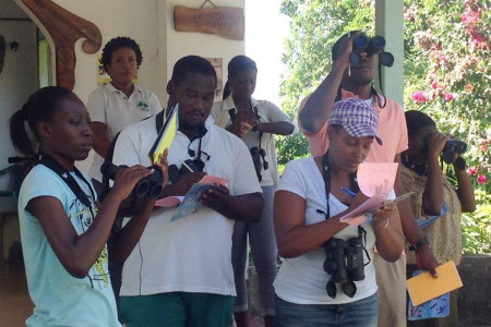 Teachers practice bird identification outdoors at KIDO Foundation and record their observations in their birding notebooks. (photo by Marina Fastigi)