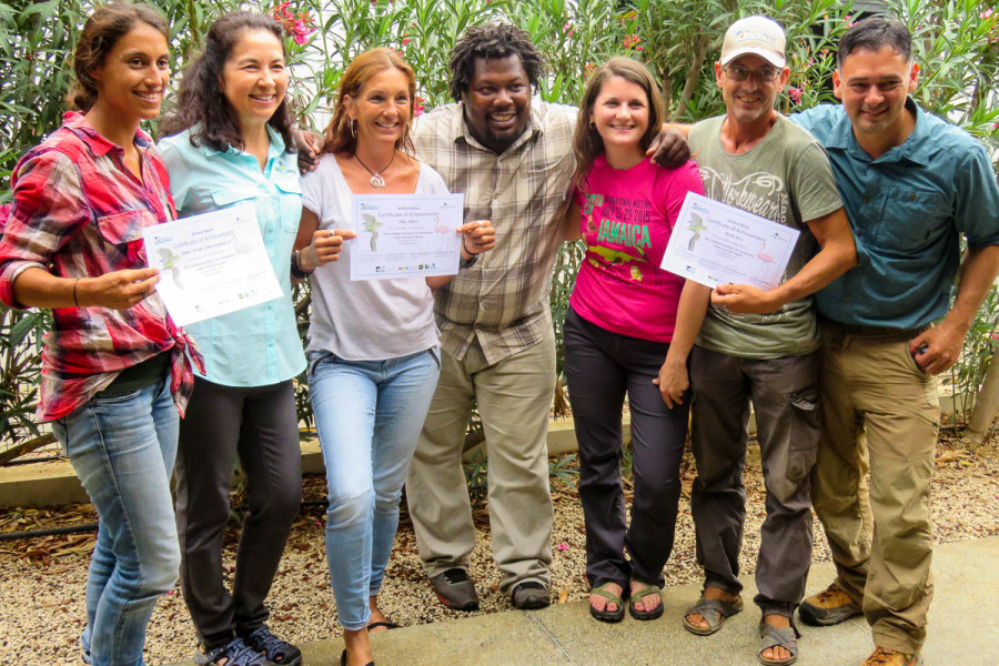 Newly-trained guides from the Mangrove Information Center pose with facilitators and their Certificates of Completion for the CBT Guide Training. L to R: Janet Koek, Lisa Sorenson, Elly Albers, Beny Wilson, Holly Robertson, Mick Arts, Rick Morales.