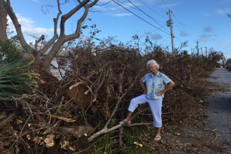 Erika Gates inspects damage at Sea Gate Lane.