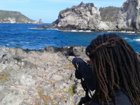 David S. Lee Fund award recipient, Grenadian Wayne Smart, scans for seabirds in the Grenadine islands with his spotting scope.