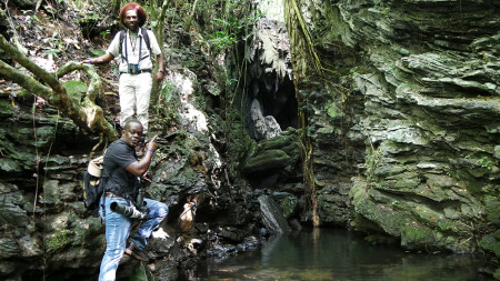 Two St. Lucian delegates, Valance (Vision) James and Adams Toussaint, pose at the gorgeous entrance of Gruta Batata, a cave with pools and waterfalls. (Photo by Jessica Rozek)