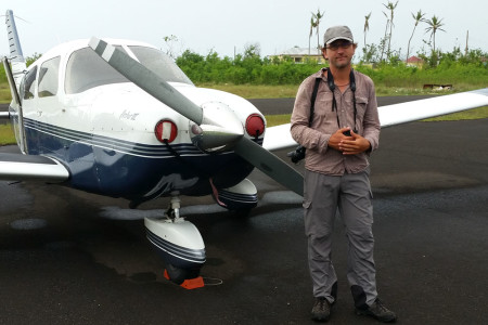 Eric Delcroix, avid birder from Guadeloupe and Frantz’s husband, stands in front of the Piper PA28 airplane before take-off (Photo by Anthony Levesque)