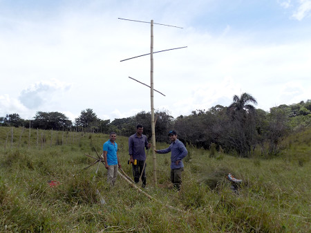 Spencer, project technician Joaris Gonzalez, and Cristián of Plan Yaque pose next to a fully assembled artificial perch. (photo by Kim Shoback)