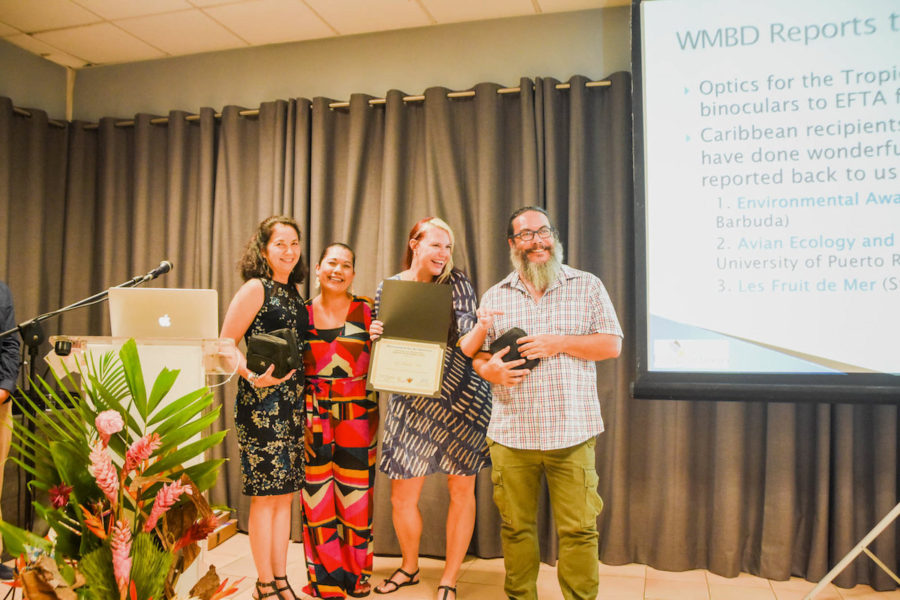 Les Fruits de Mer (Jenn Yerkes and Mark Yokoyama on right) receiving recognition and binoculars for turning in reports of their World Migratory Bird Day activities. 