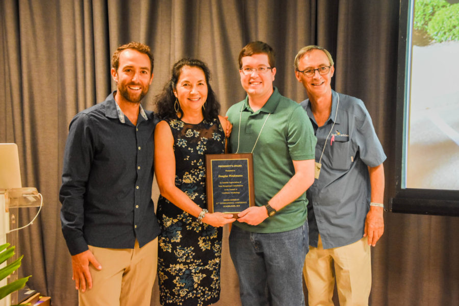 Doug Weidemann (second from right) accepts a President's Award for more than a decade of work he has invested into the Journal of Caribbean of Ornithology. (photo by Mark Yokoyama)