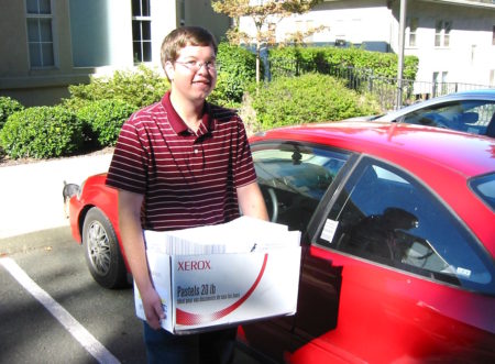 Doug Weidemann with box of printed Journal of Caribbean Ornithology issues ready to mail out.