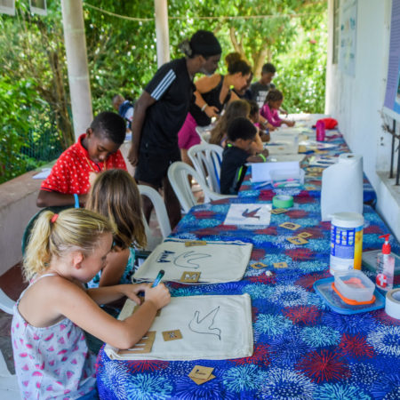 Young artists at work on bird-themed bags