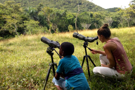 Peregrine Fund seasonal biologist, Sete Gañan, observes released Ridgway’s Hawks along with a young community member from Los Brazos. Everyone in the community showed a great interest in the project, and we had visitors both young and old almost every day during the releases