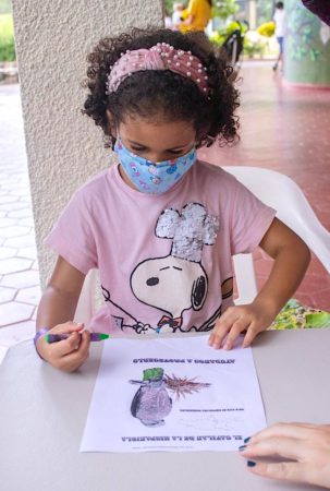 Child coloring in a Ridgeway's Hawk