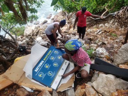 People unpack Wildlife Reserve sign