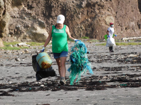 Participants collecting trash at the beach clean-up.