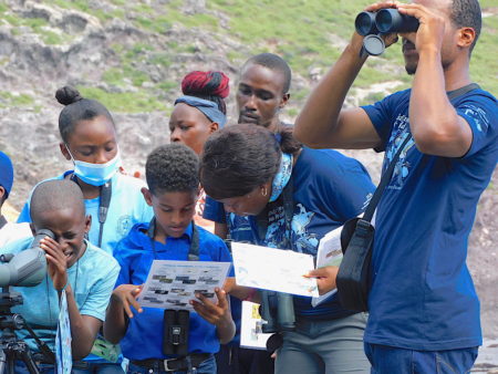 Schoolchildren looking at shorebirds in Montserrat