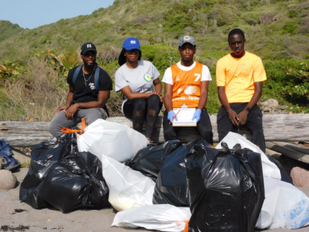 Some of the participants of the beach clean-up with the trash they collected
