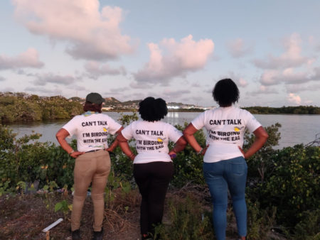 Posing with t-shirts saying "Can't Talk I'm Birding with the EAG"