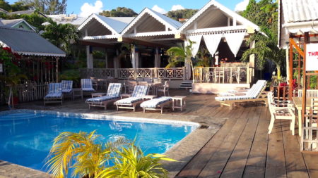 Photo of a caribbean-owned accomodation with pool and deck.