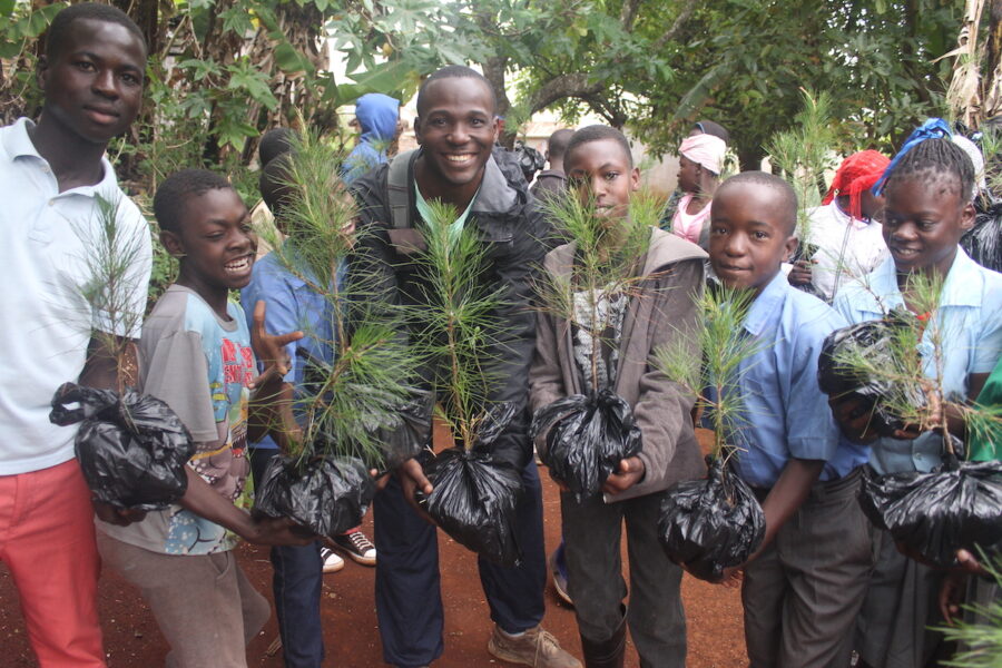 Anderson Jean (center) with Haitian schoolchildren planting trees for the Caribbean Endemic Bird Festival. 