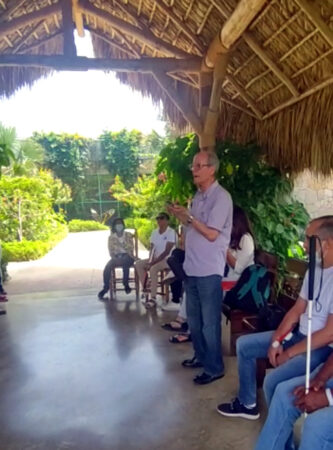 Simon Guerrero plays bird calls for participants of a birding event for blind people