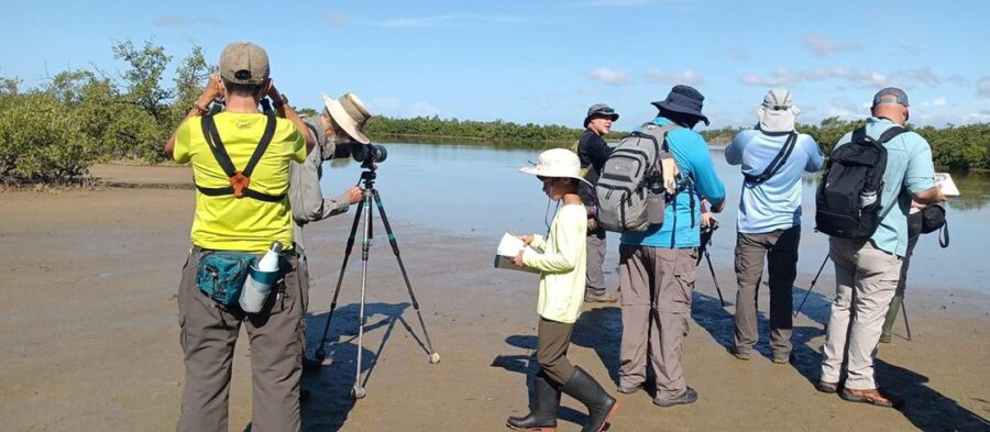 A group bird watching at a wetland