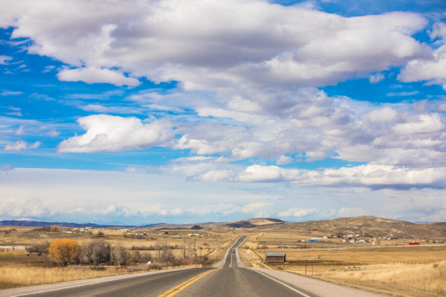 The picturesque plains and mountains that greeted Chris on his way to Casper, Wyoming as seen from the bus on a highway.