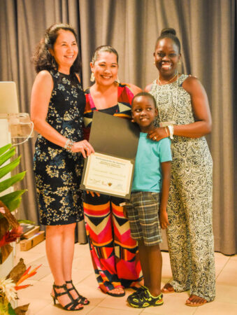 Natalya Lawrence receiving an Educators' Award from Lisa Sorenson and Sheylda Diaz-Mendez, and Natalya's son Jordan, already an avid birder! (BirdsCaribbean Conference in Guadeloupe, July 2019)