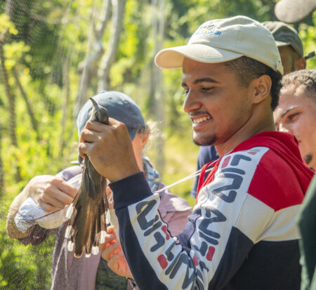 https://www.birdscaribbean.org/wp-content/uploads/2023/05/Elvin-removing-a-cuckoo-from-the-mist-net-Josh-Covill-Cropped-450x413.jpg