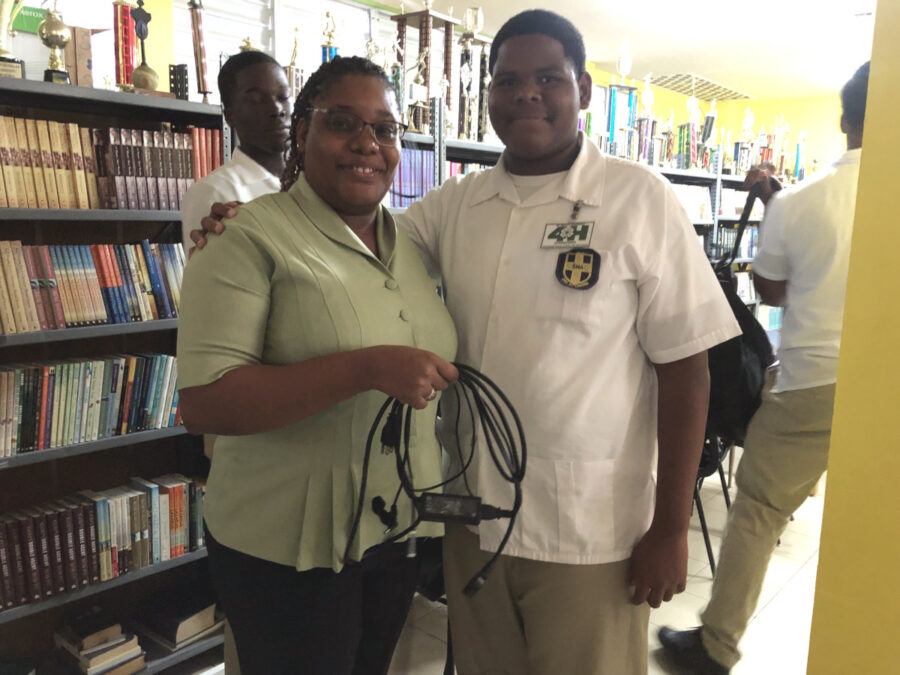 A St. Mary’s Teacher who acted as a hazardous power line poses with the student “petrel fledgling” that survived the Diablotin Obstacle Course