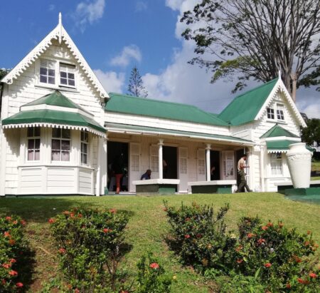 Curator's House at the Botanical Gardens of St Vincent and the Grenadines. House is of classical Colonial architecture, simply painted in white with a green roof.