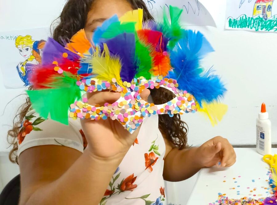 Girls with decorated bird mask.