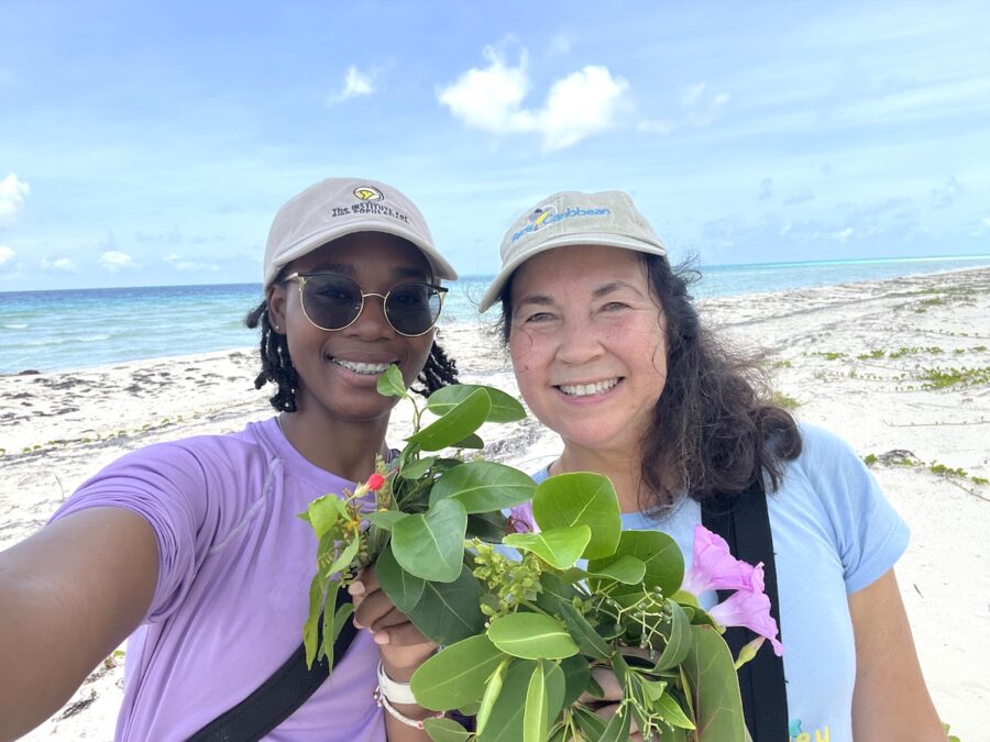 Photo (selfie) of two women holding various plants.