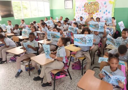 Students reading the WMBD brochure in a classroom.