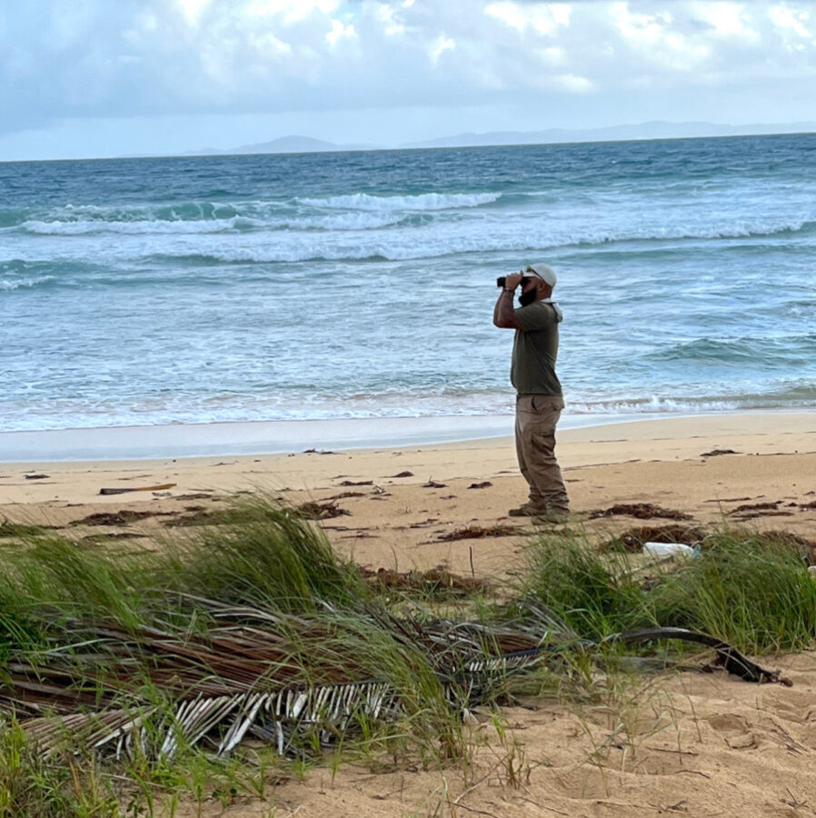 Man looking through binoculars
