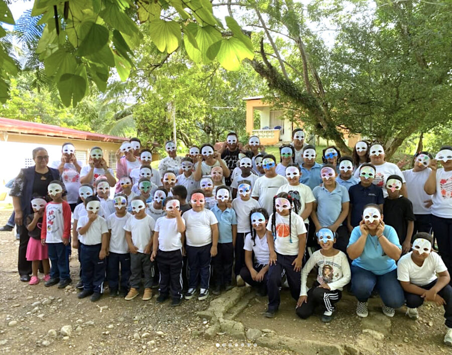Group photo of students wearing bird masks. 